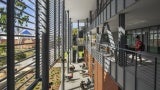 Perpendicular view of an external screen and balcony at an educational building.