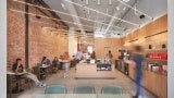 Coffee shop interior with exposed brick wall and light wood cabinetry