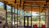 Interior lobby space with view to the outdoors through glass curtain wall. 