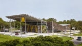 Exterior view of a McDonald's surrounded by trees. 