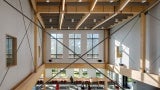 View of a cafeteria from above. The internal supporting structure is timber.