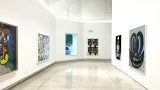 White gallery space with art displayed. 