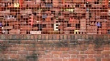 Existing brick planter wall augmented with custom welded gabion cage and filled with salvaged bricks from the Irwin Block (1892-2022) and First Christian Church tower (1942-).