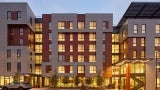 Distinct entries to two different buildings on either side of shared entry court. 
