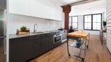 Modern spacious kitchen, large windows on far wall