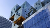Exterior angle view of multiple styles of modern buildings against a clear sky. 