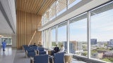 Arrival at a care community features a two-story, connected atrium with expansive views.
