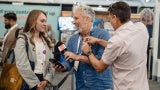 mike chapman interviews attendees expo floor