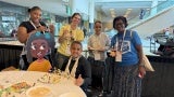 Students and teachers pose with Deja the Dynamo.