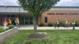 workers wearing personal protective gear and walking in the same direction