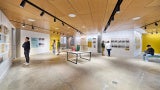 Museum attendees looking at architecture exhibit