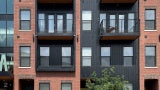 four story brick and black residential building in the neighborhood of play