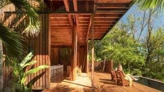 Two people sitting by the pool of the Costa Rica Treehouse