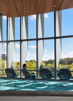 Person sitting by window inside of University of Illinois at Chicago, Academic and Residential Complex (UIC ARC) 