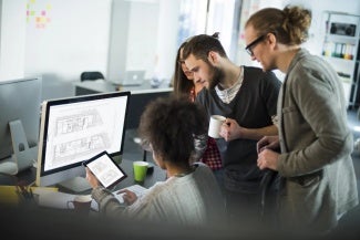 Group of colleagues working at a computer