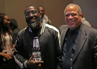 Two men posing and smiling together