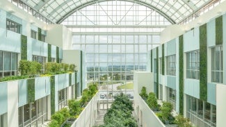 Interior space with a glass ceiling and plants 