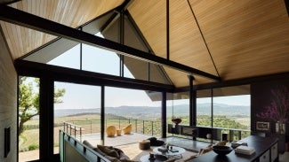 Three Gables home interior living room looking out to deck and rolling hills