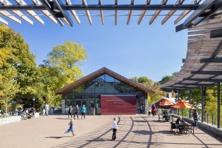 View from under overhang toward Conservation Pavilion where children are playing.