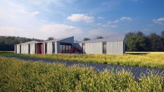 Exterior of OpenHome in an open field with gravel driveway.