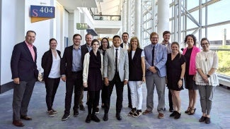 A group of 14 people leaders of the Young Architects Forum and AIA Large Firm Roundtable.