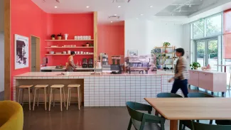 Checkout counter and bar seating inside of Liberation Coffee House 