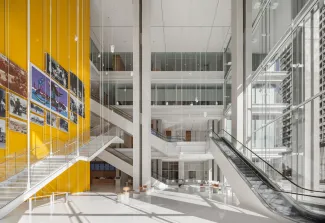 MAIN ATRIUM LOOKING NORTH WITH PUBLIC ELEVATOR CORE ON LEFT WITH LOCAL HERITAGE IMAGES. CONVENIENCE STAIR AND ESCALATORS LEAD UP TO HIGH TRAFFIC COURTS ON 2ND FLOOR AND COURT SERVICES ON 3RD FLOOR