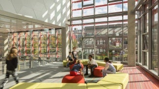 Interior gathering space of Seattle Academy of Arts and Sciences Middle School on a sunny day.