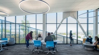 People working in a shared workspace inside