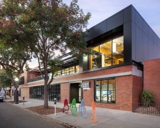 View to new DPR entry and level 2 mass timber addition, exterior façade restored to original building materials.