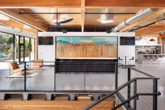 View from communicating stair to open collaboration area in mass timber addition showcasing the seed wall.