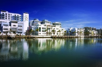 a series of multifamily residential buildings along a riverfront.