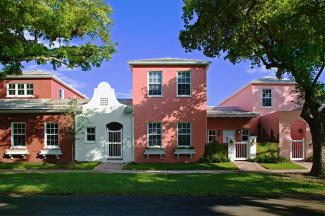 Single family brick rowhouses along a tree-lined street