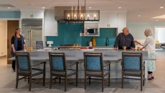 Residents convene in open kitchen area. 