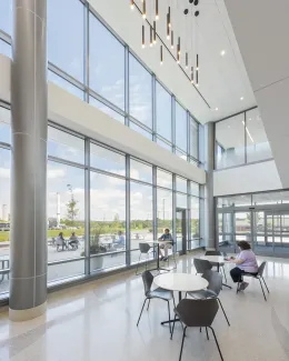 THE DOUBLE-HEIGHT LOBBY ALLOWS AN ABUNDANCE OF NATURAL LIGHT INTO THE ENTRY, PROVIDING VIEWS OUT TO THE CAMPUS.
