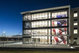 AT NIGHT, THE BUILDING'S MULTI-STORY WALL GRAPHIC DEPICTING THE AMERICAN FLAG TAKES CENTER STAGE AND IS TRANSFORMED INTO AN ILLUMINATED FEATURE.