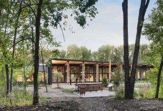 The building, sited near the marshy wetland of Westwood Lake, captures roof rainwater to minimize impact on the watershed.