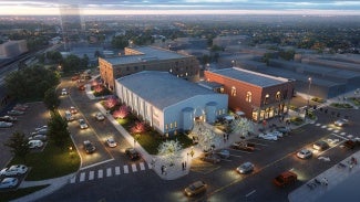 Aerial rendering of an adaptive reuse building at dusk.