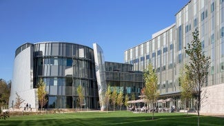 science building at day with glass windows and curved facade