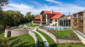 exterior view of a state park lodge with outdoor pool in the foreground