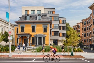 View of adaptive reuse project from the street. Behind the historic structure, there is a new addition. 