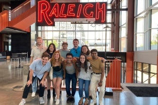 A group of people posed for a photo in a Convention Center 