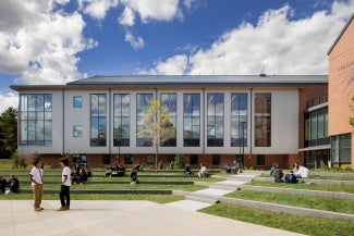 Exterior view of a school with terrace landscaping at daytime. 