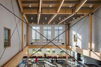 View of a cafeteria from above. The internal supporting structure is timber.