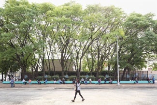 Residents take shade under the trees at The Refreshing Waters.