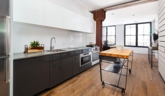 Modern spacious kitchen, large windows on far wall