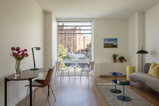 Studio apartment with window facing historic Armory.