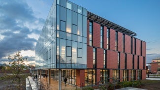 Corner exterior view of building against a cloudy sky