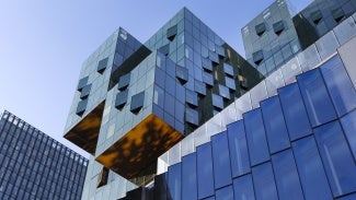 Exterior angle view of multiple styles of modern buildings against a clear sky. 