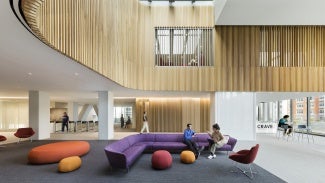 The skylit 6th floor lobby serves as a student social space, providing access to residential living and a café.